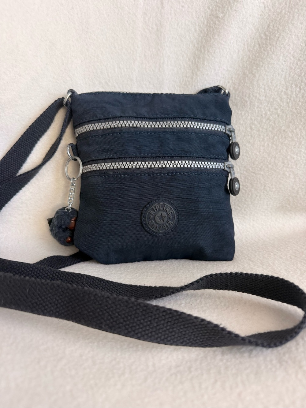 Kipling Navy Mini Crossbody Bag with Pom in Key Charm